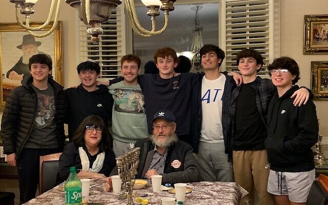 Teenagers from Saint Francis School, The Weber School and Riverwood High School joined Sabi and Robin Varon for a pre-Chanukah party and learning session. From left, is Ian Maman, Ilan Cheskes, Mick Shrubstock, Zach Friedman, Cooper Bernath, Jake Friedman and Zack Siegel. Hosts Robin and Sabi Varon are seated in front.