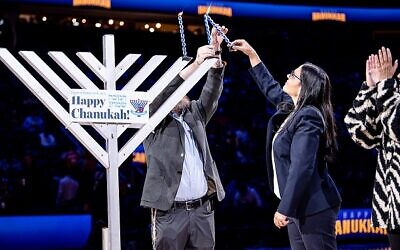 Anat Sultan-Dodan, Consulate General of Israel in Atlanta, was on hand at State Farm Arena on Dec. 19 to help light the menorah for the team’s Chanukah celebration. // Photos by Atlanta Hawks
