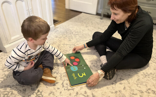 Speech pathologist Laurie Botstein works with a young client during a Floortime activity.