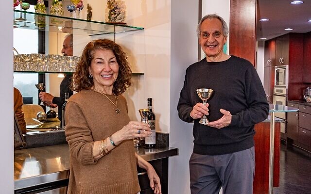Lilly and Mark Antebi enjoy a glass of wine in their collection of sterling silver kiddish cups // Photos by Howard Mendel