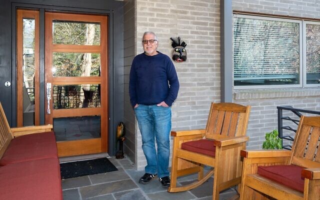 Larry Pett enjoys the front porch leading in to the professional touches he designed within for style and efficiency - like 22 solar panels.