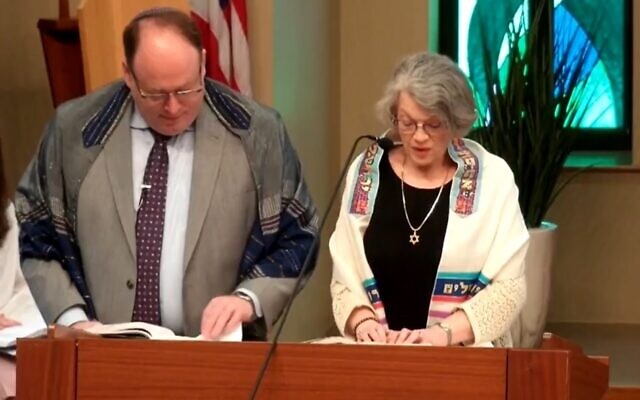 Debbie Rubin along with Rabbi Jordan Ottenstein reciting a prayer.