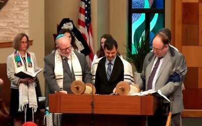 After practicing for about a year, Eric Cole reads his Torah portion with his grandfather’s talis.