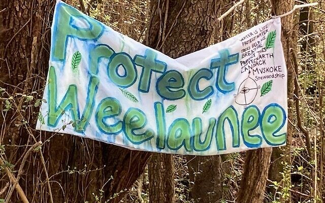A protest banner. "Weelaunee" was what the Muscogee tribe called the South River Forest.