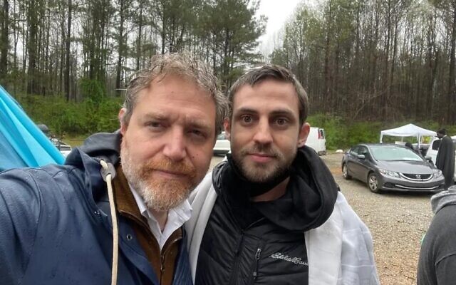 Rabbi Mike Rothbaum (left) and Adam Brunell at a March 11 memorial service, where the family of the protestor killed by police scattered their ashes in the forest.