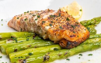 Salmon entrée was char-grilled over thick asparagus // Photo Courtesy of Nowak’s