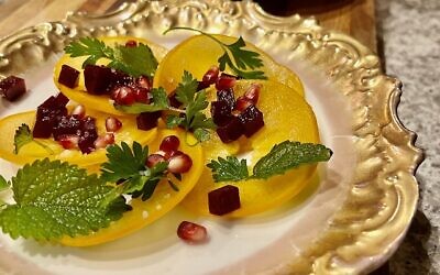 Compressed persimmon salad with pomegranate seeds, salt baked beets, parsley, and mint.