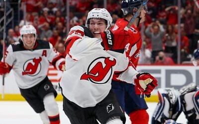 Only days after wrapping up his collegiate career at the University of Michigan, Luke Hughes (front and center) celebrates his first NHL goal, a game-winner in the regular-season finale, as older brother Jack Hughes looks on // Photo Courtesy of New Jersey Devils
