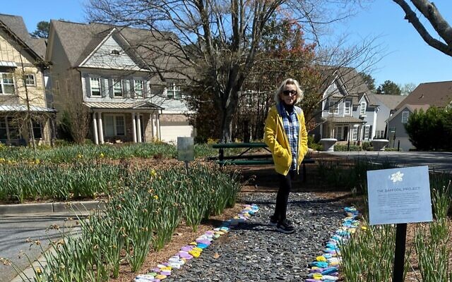 Irene Yabrow keeps the Stones of Remembrance path tidy at Jewish Family & Career Services.