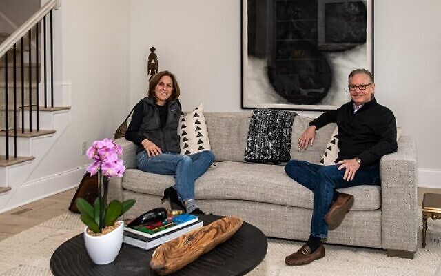 Andrew and Janice Dietz relax in their living room in front of “Three Lemons and Egg,” by Donald Sultan, and a Louise Nevelson painted wood sculpture // Photos by Howard Mendel