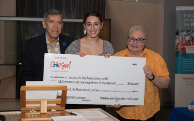 Audrey Zeff receives the Chesed Community Service Award Essay Prize (Weinroth Award) from Michael and Linda Weinroth // Photo Credit: Glenn Prince