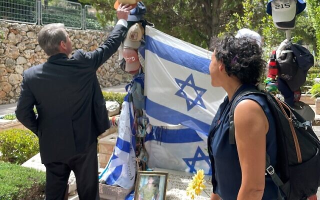 Emanuel Fialkow took this shot of Gov. Kemp placing an Atlanta Braves cap on a fallen Israeli lone soldier.