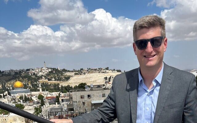The Atlanta Journal-Constitution reporter Greg Bluestein poses in front of a view of Jerusalem. Bluestein sent reports back to the AJC documenting the trip.