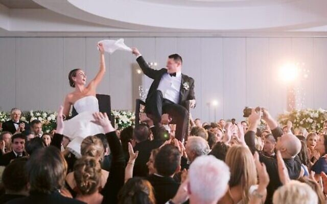 Chairs held high for the Hora // File Photo