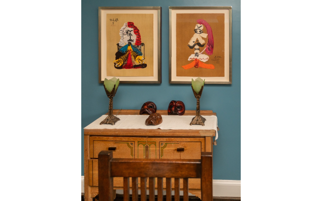 Art deco furniture from New York was selected by spouse, Nicole. The leather masks from an Italian Commedia del’Arte mask maker are highlighted by two of the limited Picasso editions.