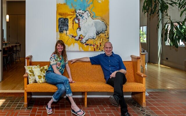 Below: Laura and Andrew enjoy the pew they rescued from a small church in Reynoldstown, which they recovered. Above is the “Bulldog” painting by family friend Bradford Moody.
