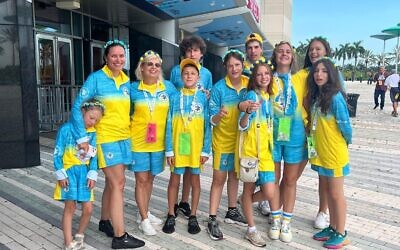 The Ukraine delegation, including athletes, coaches, and delegation head, preparing to enter the FLA Live Arena, as they joined more than 2,000 teen athletes from 64 delegations and eight countries for the opening ceremony // Photo Credit: Jason Edelstein