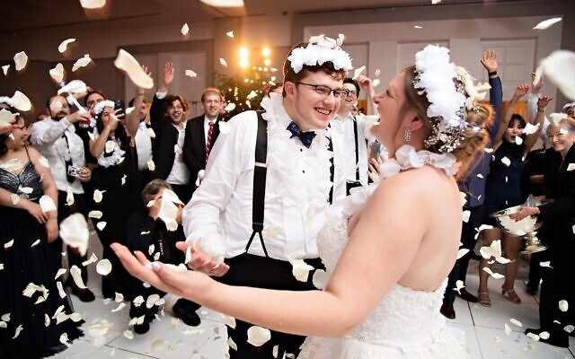 Guests threw white rose petals to celebrate the couples wedding  //  Photos by Jamie Reichman