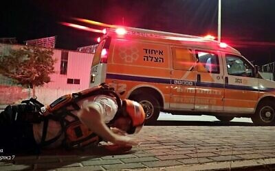 A United Hatzalah ambulance crewman takes cover during an air raid siren Oct. 8, 2023 near the Gaza border // Photo credit: United Hatzalah of Israel