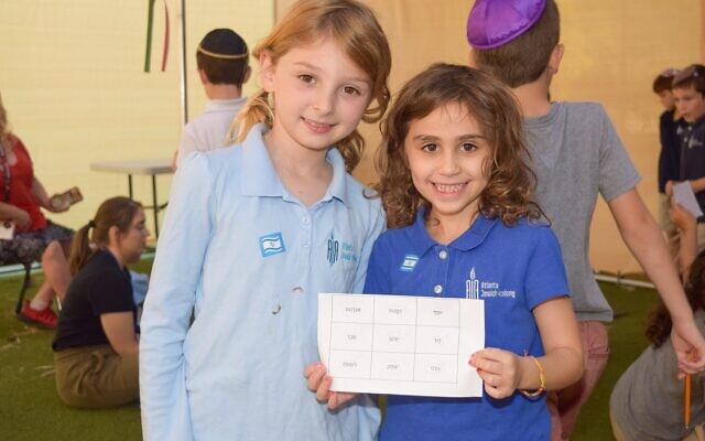 A pair of AJA students are pictured celebrating Sukkot.