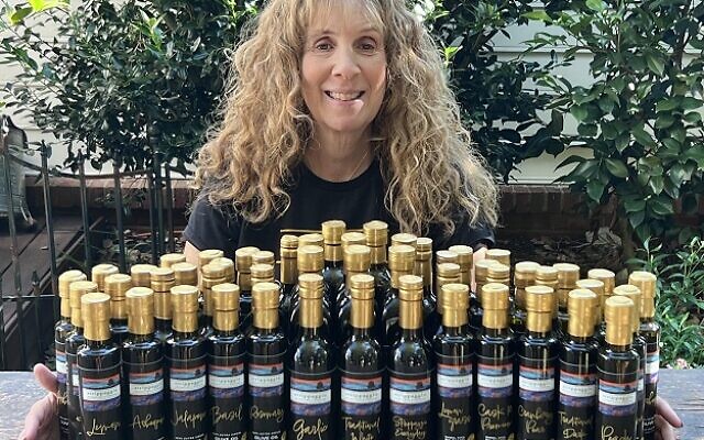 Ellen Softness with her arms around a bevy of Strippaggio bottles.