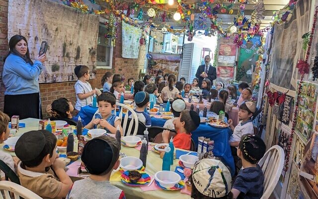Torah Day School students enjoy lunch in the sukkah.