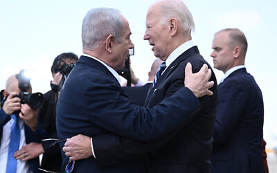 Prime Minister Benjamin Netanyahu (L) greets US President Joe Biden upon his arrival at Tel Aviv’s Ben Gurion airport on Oct. 18, 2023 // Photo Credit: Brendan SMIALOWSKI/AFP/Times of Israel