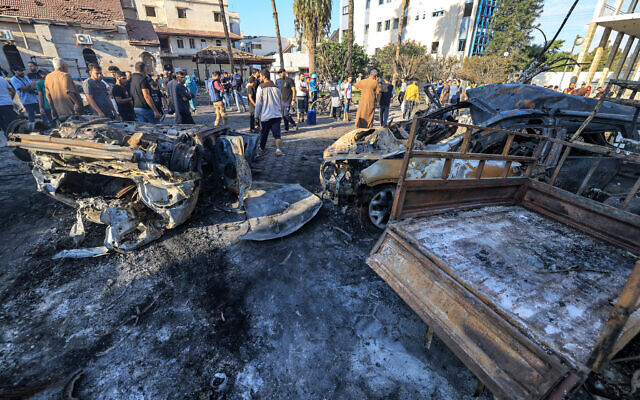 People search through debris outside the site of the Ahli Arab hospital in central Gaza on Oct. 18, 2023 in the aftermath of a blast there // Photo Credit: MAHMUD HAMS/AFP/Times of Israel