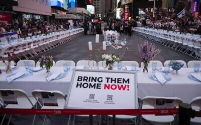An empty shabbat table symbolizing the over 200 hostages held by Hamas in Gaza, in Times Square, New York City, Oct. 27, 2023 // Photo Credit: Luke Tress via JTA/Times of Israel