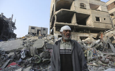 A Palestinian stands outside the building destroyed in an Israeli airstrike in the Gaza Strip in Rafah, Wednesday, Oct 25, 2023 // Photo Credit: AP Photo/Hatem Ali