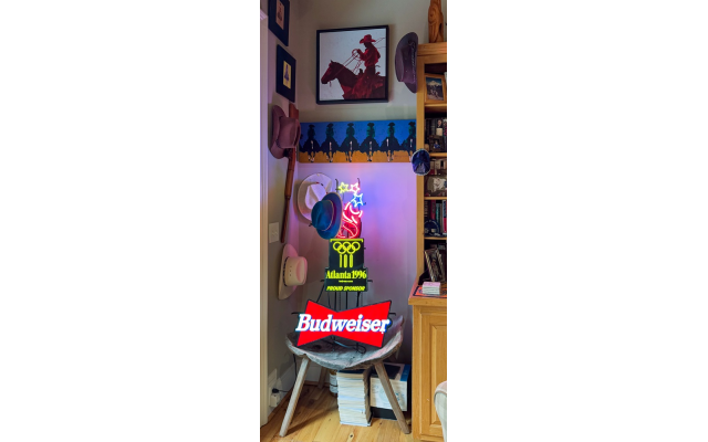 As a diversion from Western art, hanging in Bauer’s den is his prized neon Budweiser sign from the 1996 Atlanta Olympics.