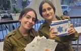 Two women Israeli soldiers show the lovely cards made by students at Torah Day School in Atlanta.