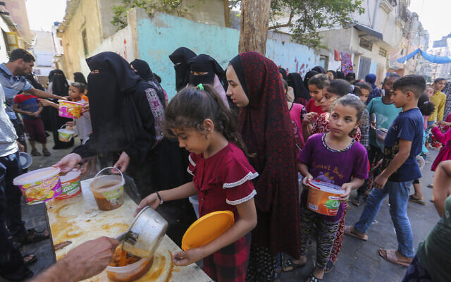 Palestinians receive food in Rafah, southern Gaza Strip, Wednesday, Nov. 8, 2023 // Photo Credit: AP Photo/Hatem Ali/Times of Israel
