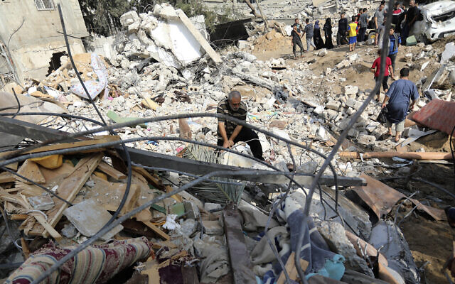 Palestinians inspect the damage of a destroyed house following Israeli airstrikes on Gaza City, Wednesday, Nov. 8, 2023 // Photo Credit: AP Photo/Abed Khaled/Times of Israel