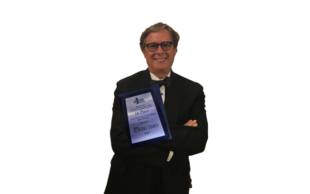 Michael Morris, AJT owner and publisher, proudly holds the first-place award for all to see.