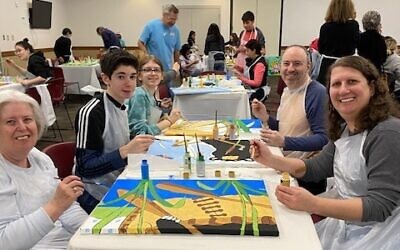 Hurewitz family works on three canvasses during Paintfest at the MJCCA.