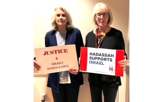 Lynn Owens and Simone Wilker, HGA Zionist Affairs Chair, show signs of support for Israeli women and girls.