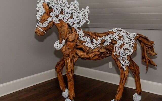 This wood horse was a gift to the Hollands before Hillary painted over some of the pewter in white.