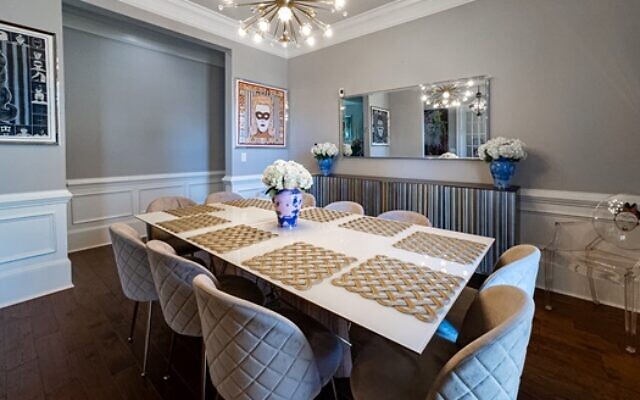 The Holland dining room has a Jonathan Adler sputnik chandelier and clear plastic chairs by Phillip Strack for Kartell.