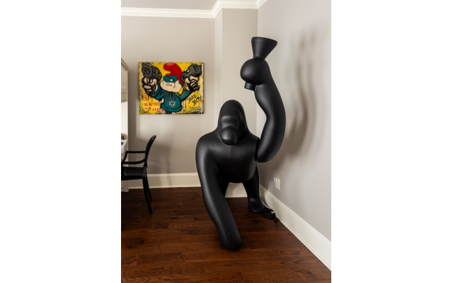The boy’s bedroom has a life-sized gorilla lamp and a Poppa Smurf “Gang” photo from an Israeli gallery.