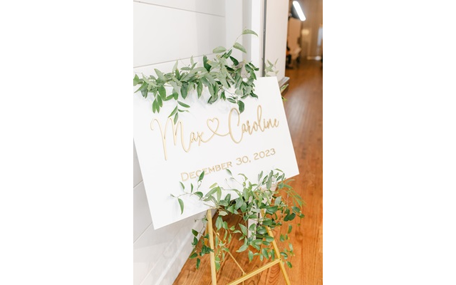 The wedding easel greeted guests in gold script.