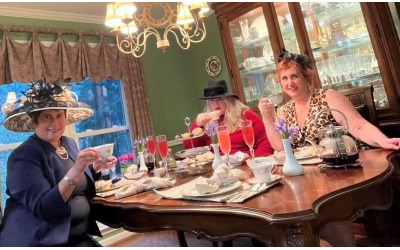 Terri Hitzig (far right) celebrates afternoon tea with friends, Leana Kart and Hilary Eiseman, who traveled with her to nail down the concept.