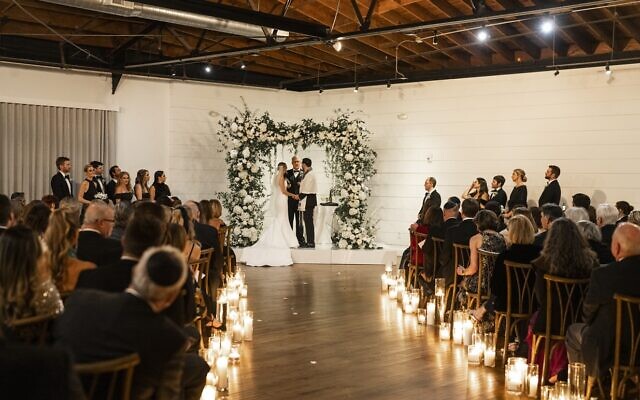 The chuppah was comprised of white florals amidst twinkling candles.
