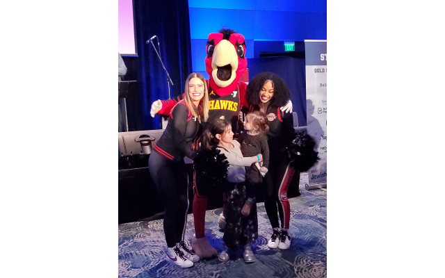 The Atlanta Hawks dancers pose with Harry the Hawk for a picture with fans.