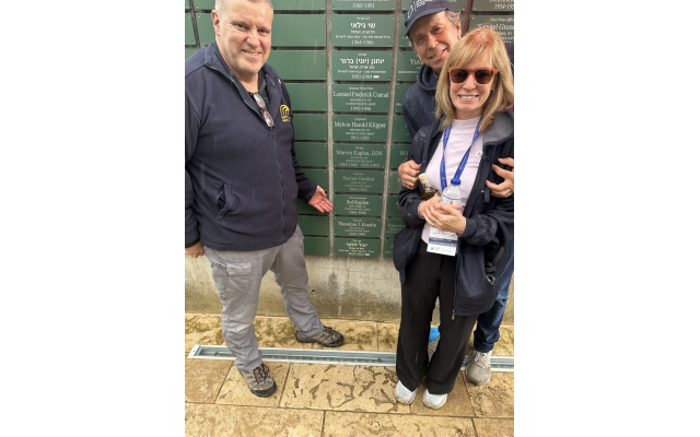 (From left) Alon Wald joins Barbara and Alan Kaplan at the Wall of Honor in front of the plaque dedicated to the Kaplans’ fathers, Homer Gordon and Marvin Kaplan.