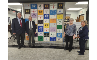 Pictured, from left, are Pinch Hitter Program Founder Judge Gary Jackson, Chair Harry Lutz, volunteer coordinator Rosanne Lutz, and Helen Sherrer-Diamond presenting the quilt in the Atlanta Jewish Times newsroom.