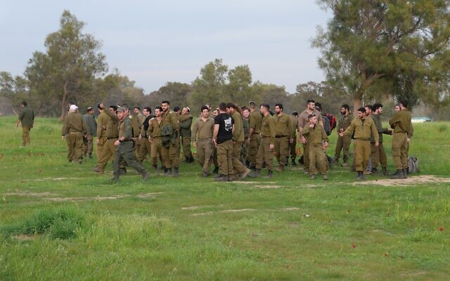 A group of IDF soldiers gather at the site of the Supernova music festival massacre.