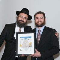 Rabbi Ephraim Silverman presented an award for courage and sacrifice to two Chabad of Cobb soldiers in Israel, including Zach Olstein, who was present at the event. Josh Asarnow, the other recipient, was with his unit in Israel.