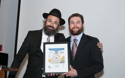 Rabbi Ephraim Silverman presented an award for courage and sacrifice to two Chabad of Cobb soldiers in Israel, including Zach Olstein, who was present at the event. Josh Asmarow, the other recipient, was with his unit in Israel.