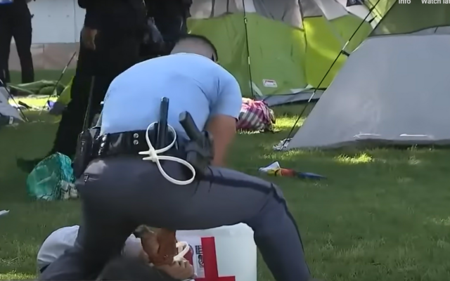 Police officers used zip ties to detain the protesters // YouTube screenshot